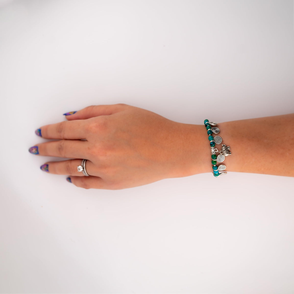 Siam Artisan Collective Boho Charm Bracelet for Women – Blue & Green Beaded Bracelet with Silver Spiral Charms and Elephant Pendant – Handmade Thai Bohemian Jewelry